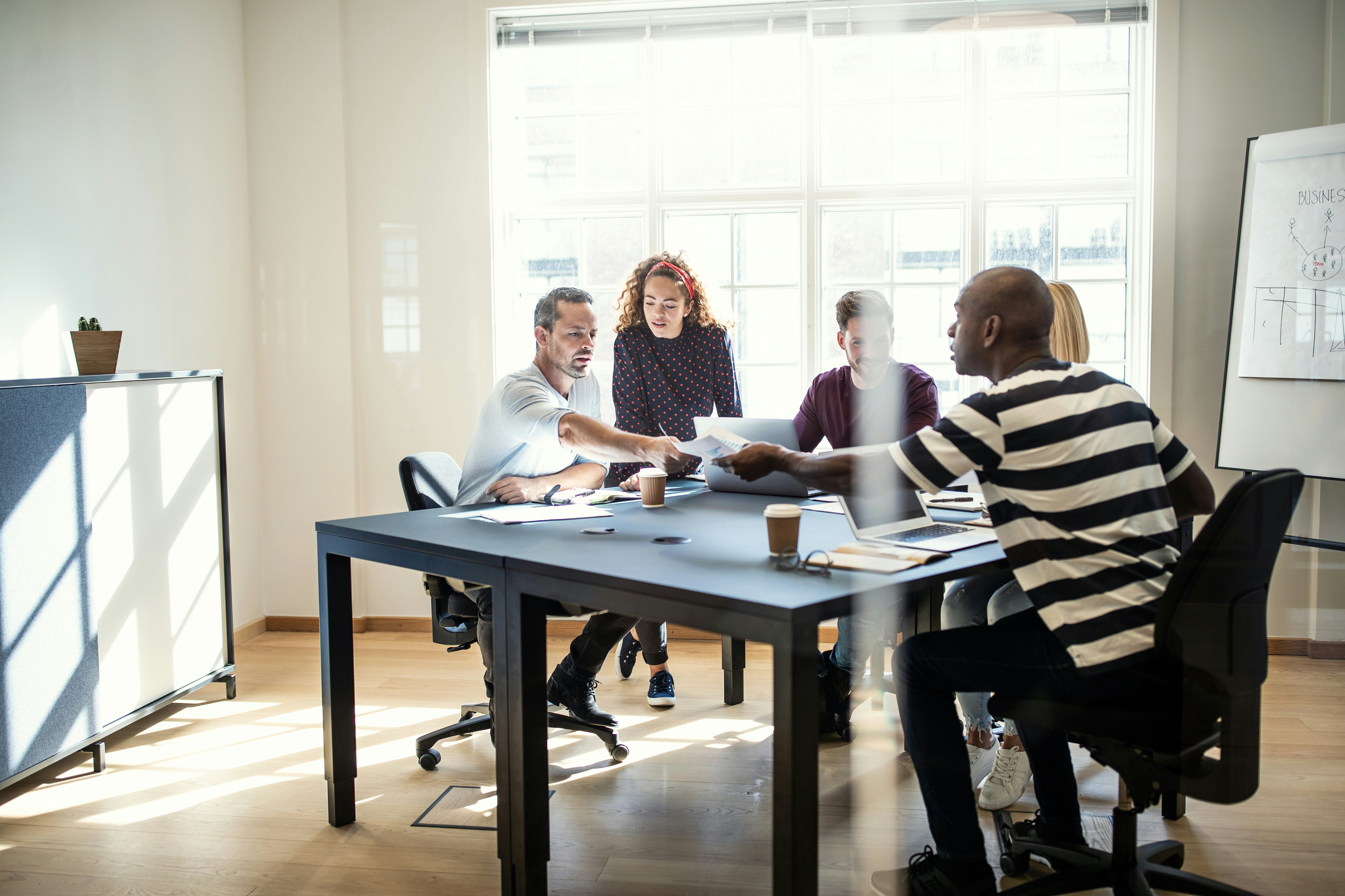 Team collaborating on insights around a table